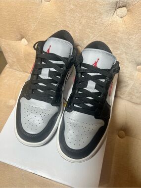Nike women’s Jordan 1 Low-Top Sneakers in Black, Gray and Red
